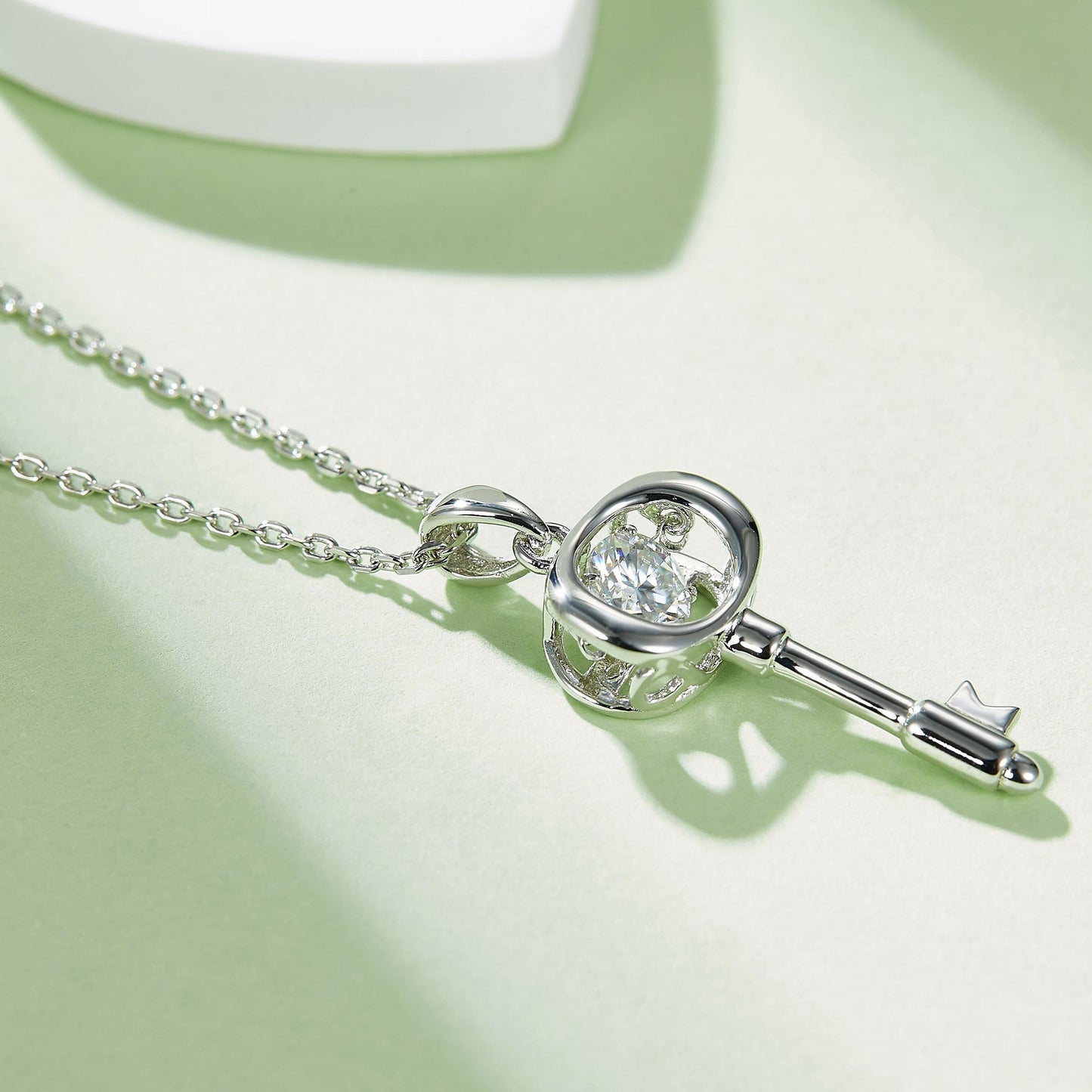 Moissanite pendant with rotating brilliance on a silver chain