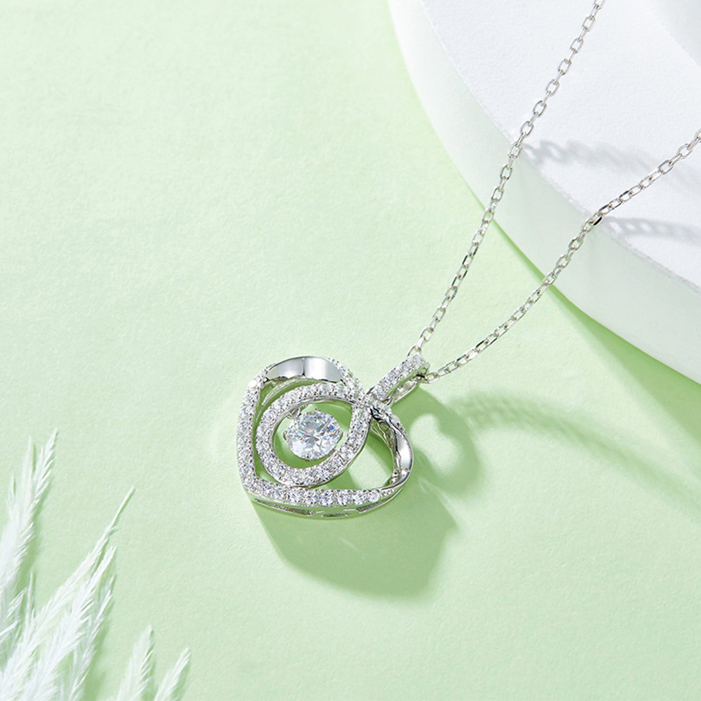 Moissanite pendant with rotating brilliance on a silver chain